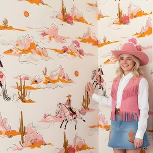 May include: A room decorated with a Western theme. The walls feature wallpaper with a repeating pattern of cowboys on horseback, cacti, and desert landscapes in pink, orange, and black. A pink rug and pillows complement the theme. A person is wearing a pink cowboy hat and vest.