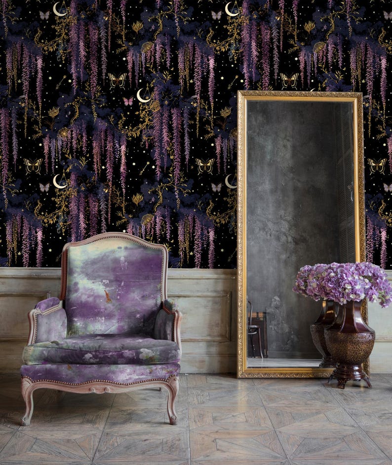 May include: A room featuring a purple velvet armchair, a large gold-framed mirror, and a dark floral wallpaper with wisteria, butterflies, and moons. A vase of purple flowers sits near the mirror. The floor is tiled.