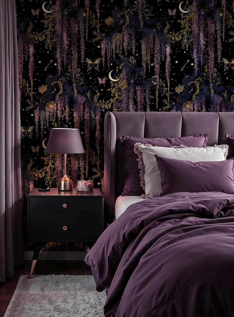 May include: A bedroom scene featuring a dark purple bed with matching bedding and pillows. A black nightstand with a lamp and a decorative wallpaper with a floral and celestial design. A purple curtain is on the left.
