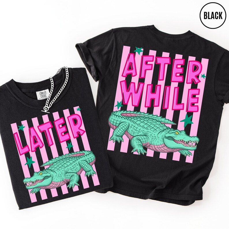 Puede incluir: Dos camisetas negras con un dise&ntilde;o gr&aacute;fico. Cada camiseta presenta una ilustraci&oacute;n de un caim&aacute;n verde con texto rosa que dice "LATER" y "AFTER WHILE". El dise&ntilde;o incluye rayas rosas y estrellas verdes.
