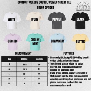 May include: A display of Comfort Colors 3023CL boxy tees in various colors: white, ivory, pepper, black, orchid, chalky mint, chambray, and butter. A size chart shows measurements in inches. Features include heavyweight cotton fabric, a boxy fit, and a relaxed style.