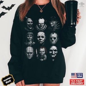 May include: Black Champion sweatshirt featuring a collage of horror movie villains. The graphic includes faces of iconic characters like Pennywise, Michael Myers, and Freddy Krueger. The sweatshirt has a crew neck and long sleeves. The text "PRINT IN USA" and "FAST DELIVERY" are also visible.