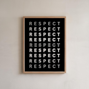 May include: A rectangular wall art print in a light wood frame featuring a black background with the word RESPECT printed in white capital letters nine times in a vertical column, with the fifth instance appearing in a white outline style.