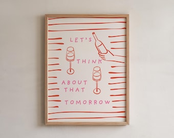 May include: Framed art print with a light wood frame. The print features red and pink text and illustrations on a cream background. The text reads "LET'S THINK ABOUT THAT TOMORROW" with images of wine glasses and a bottle.