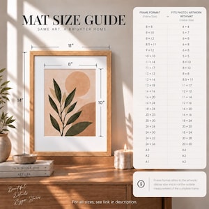 May include: A mat size guide chart with text and a framed print featuring a botanical illustration of dark green leaves against a peach-colored sun and landscape. The frame is labeled with dimensions of 11 inches by 14 inches and 8 inches by 10 inches.