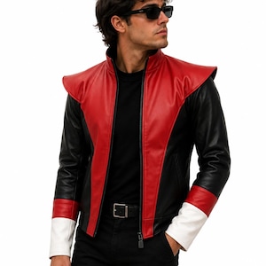 May include: A jacket featuring a red front panel, black sleeves, and white cuffs. The garment has a high collar, a full-length front zipper, and extended shoulder detailing. The design incorporates a color-blocked pattern with black side panels and a black interior lining, providing a structured look.
