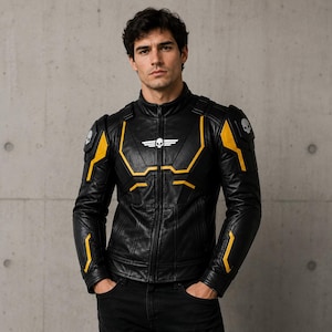 May include: A black leather jacket featuring yellow geometric accents, a high collar, and a central zipper. The chest displays a white winged skull emblem, while each shoulder pad is decorated with a small white skull icon on a black background.