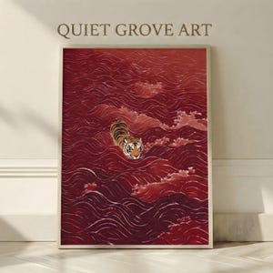 Peut inclure: Impression d'art encadrée représentant un tigre nageant dans une mer de vagues rouges. Le tigre a des rayures orange et noires, et l'œuvre est intitulée "QUIET GROVE ART". L'œuvre est présentée dans un cadre blanc.