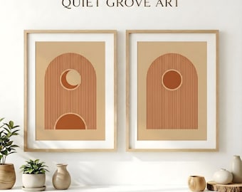 May include: Two framed art prints with a minimalist design. Each print features a terracotta arch shape with vertical lines, a circle or crescent moon, and a beige background. The text "QUIET GROVE ART" is above the frames.