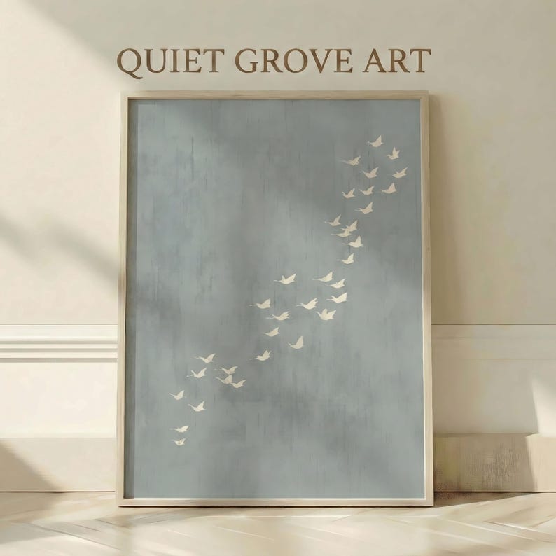 May include: A framed art print featuring a flock of white birds ascending against a muted blue background. The artwork is rectangular and framed in a light wood. The text "QUIET GROVE ART" is printed at the top.