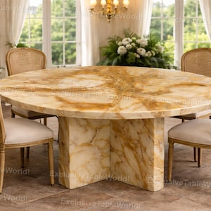 May include: A circular dining table with a marble top and a pedestal base. Four chairs with woven backs and cream-coloured seats surround the table. The room is bright with large windows and a chandelier.