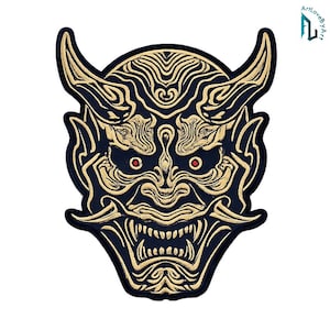 May include: A black and gold embroidered patch featuring a stylized Japanese Hannya mask design. The mask has prominent curved horns, sharp teeth, and small red pupils set against a dark background with intricate gold line work detailing.