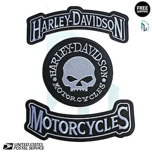 May include: A white ceramic mug with a black handle and the text "But First, Coffee" in a bold, black font. The mug is set against a blurred background, suggesting a cozy setting. The mug appears to be approximately 4 inches tall.