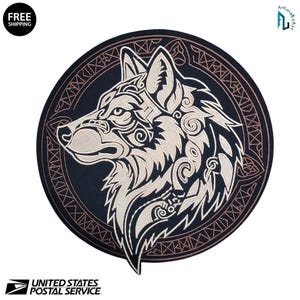 May include: Circular patch featuring a detailed, stylized wolf head in cream-colored thread against a dark blue background. The wolf design incorporates intricate patterns and is surrounded by a decorative border. The patch has the text "FREE SHIPPING".