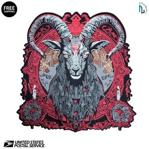 May include: Embroidered patch featuring a detailed illustration of a goat with large horns, intricate patterns, and red accents. The patch has a black border and a complex design, suitable for jackets or bags.