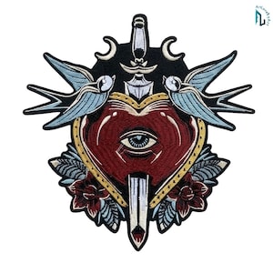 May include: An embroidered patch featuring a central red heart with a single blue eye in the middle, pierced by a silver dagger. The design includes two light blue swallows, dark red flowers, and two white crescent moons on a black background.