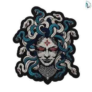 May include: An embroidered patch featuring a central face with red eyes and a red star symbol on the forehead. The figure is surrounded by numerous intertwined snakes in shades of white, light blue, and dark blue, all outlined in black thread.