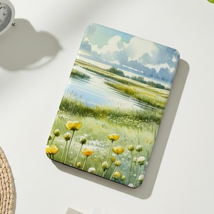 May include: Rectangular decorative tray featuring a watercolor landscape with a river, grassy banks, and yellow wildflowers. The tray has a light blue sky with fluffy clouds. The tray is on a white surface with a small potted plant and a white alarm clock.