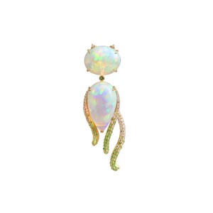 May include: A gold-toned pendant featuring two opals, one oval and one teardrop-shaped. The teardrop opal is accented with a curved, vine-like design of green and clear gemstones. A small green gemstone sits between the two opals.