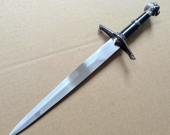 Medieval short sword, with a lion-head design, and a black scabbard attached.Artistic decorative items.