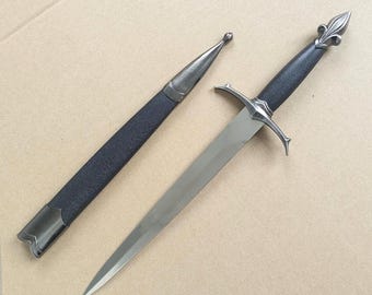 A medieval-style short sword, handcrafted, with silver pommel and floral hilt.Artistic decorative items.