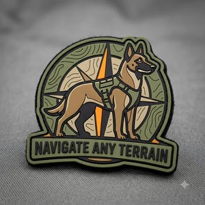 May include: A circular PVC morale patch featuring a tan Belgian Malinois dog wearing a tactical harness, standing in front of a compass rose design with olive green and orange accents. The text NAVIGATE ANY TERRAIN is printed in black.