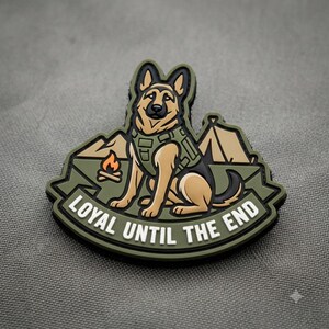 May include: A tactical morale patch featuring a tan and black German Shepherd dog wearing a green vest. The background shows a campfire and a tent. The text "LOYAL UNTIL THE END" is printed in white capital letters on a green banner at the bottom.