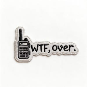 May include: Embroidered patch featuring a black and gray walkie-talkie design with the text "WTF, over." in black. The patch has a white border and is likely for clothing or accessories.