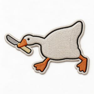 May include: Embroidered patch featuring a white goose with orange feet and beak, holding a knife. The goose is outlined in black with a cream-colored body and a white border. The patch is designed to be ironed on.