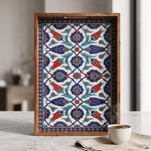May include: A rectangular wooden serving tray featuring a white base with a repeating floral pattern in shades of red, dark blue, and turquoise. The design includes stylized tulips and intricate botanical motifs framed by a dark blue border.