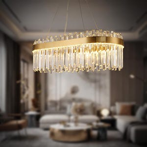 May include: A rectangular chandelier with a gold-colored frame and numerous clear crystal pendants. The light fixture is suspended from the ceiling and illuminates a living room setting. The crystals are arranged in vertical rows, creating a sparkling effect.