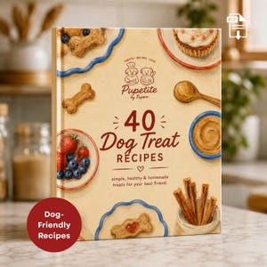 May include: A hardback book titled 40 Dog Treat Recipes by Pupetite featuring illustrations of bone-shaped biscuits, a cupcake, a bowl of berries, peanut butter, and sticks on a cream background with the text simple, healthy & homemade treats.