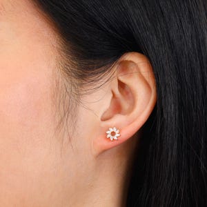 May include: A handmade wooden sign with the text "Welcome to our home" in a handwritten style. The sign is painted white with black lettering and a distressed finish, perfect for home decor.