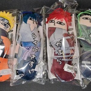 May include: Six plush character dolls in clear plastic packaging. Each doll features a different character with distinct hair and clothing colors. The dolls have Japanese text on them. The dolls are in a row on a black surface.