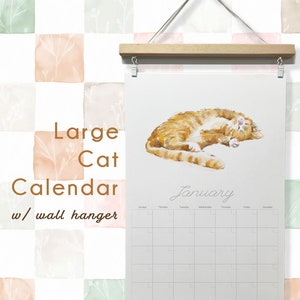May include: A large cat calendar with a wall hanger. The calendar features a watercolor painting of a ginger cat curled up on a white background. The word "January" is written in cursive. The background is a pattern of pastel squares.
