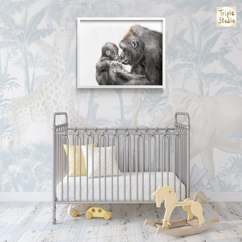 May include: A black and white illustration of a gorilla mother and baby cuddling. The image is framed in a white frame and is hanging on a wall with a blue and white jungle wallpaper.