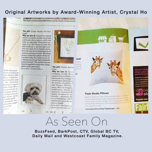 May include: A magazine page featuring artwork by Crystal Ho, an award-winning artist. The page includes a photo of a giraffe pillow, a description of the artist's work, and a list of publications that have featured her work. The text reads "Original Artworks by Award-Winning Artist, Crystal Ho" and "As Seen On: BuzzFeed, BarkPost, CTV, Global BC TV, Daily Mail and Westcoast Family Magazine."