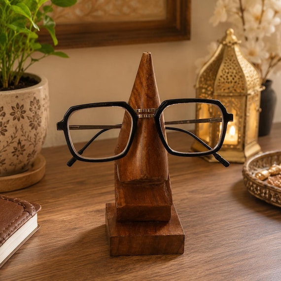 A hand-carved wooden nose that holds your glasses — absurdly functional sculpture that doubles as a conversation-starting desk centerpiece.