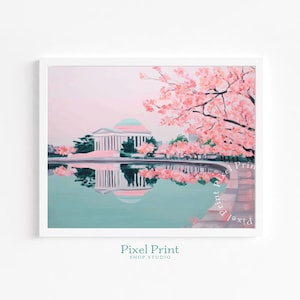 May include: A framed art print of a pastel painting featuring a neoclassical building reflected in a teal-colored body of water, with pink cherry blossoms in the foreground. The print is in a white frame. The text "Pixel Print Shop Studio" is at the bottom.