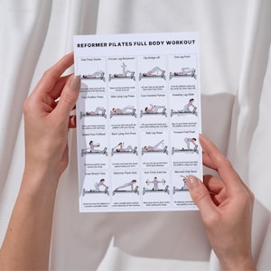 May include: A white paper titled "REFORMER PILATES FULL BODY WORKOUT" featuring illustrations of Pilates exercises. The paper is held by hands against a white backdrop. Exercises shown include "Foot Press Starter", "Circular Leg Movement", and "Hip Bridge Lift".