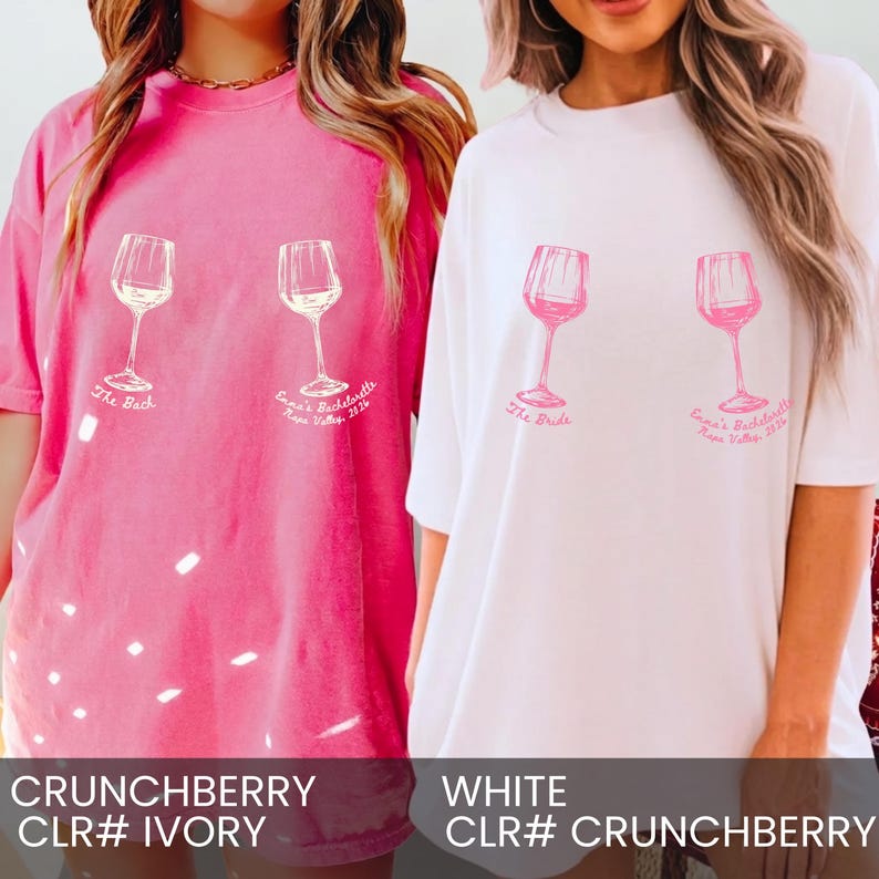 May include: A bright pink t-shirt and a white t-shirt, each featuring two wine glass graphics. The pink shirt has white text reading The Bach and Emma's Bachelorette Napa Valley 2026. The white shirt has pink text reading The Bride and Emma's Bachelorette Napa Valley 2026.