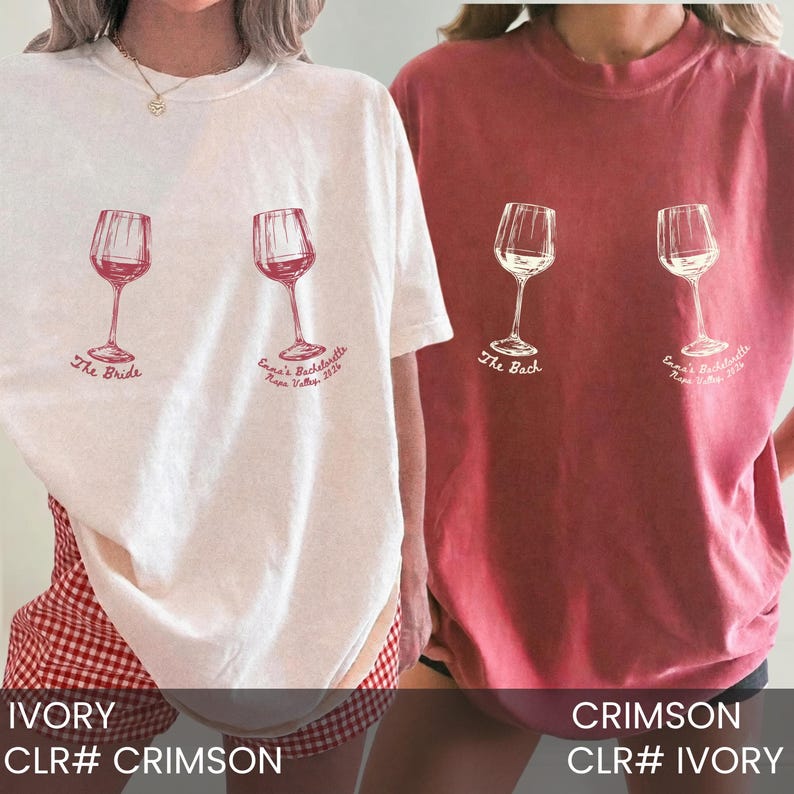 May include: Two short-sleeve crew neck t-shirts, one ivory and one crimson, each featuring two wine glass illustrations. The ivory shirt displays the text "The Bride" and "Emma's Bachelorette Napa Valley 2024". The crimson shirt displays "The Bach".