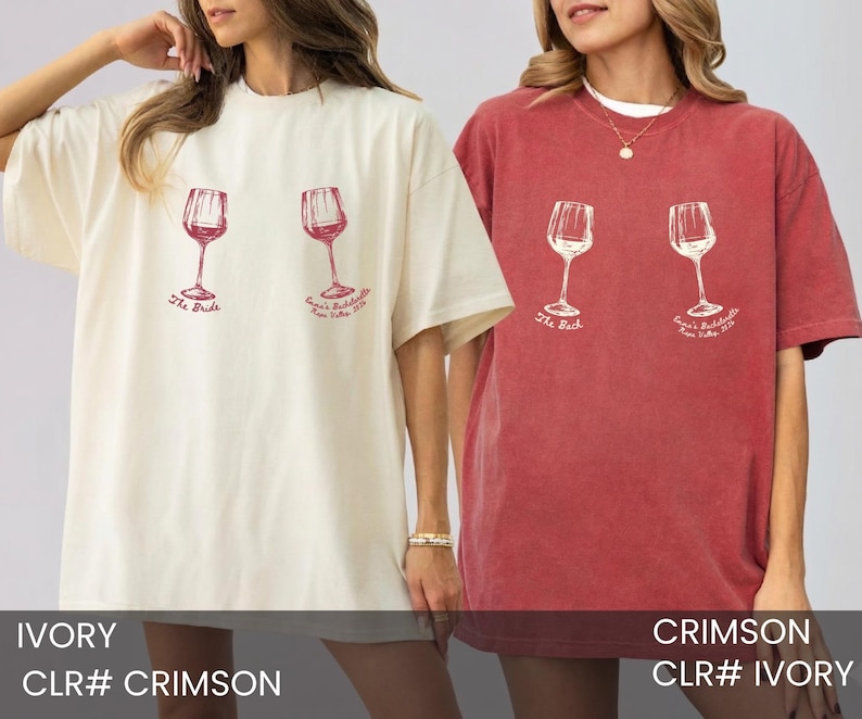 May include: An ivory t-shirt and a crimson t-shirt, each featuring two wine glass graphics. The ivory shirt has red text reading The Bride and Emma's Bachelorette Napa Valley 2024. The crimson shirt has white text reading The Bach and Emma's Bachelorette Napa Valley 2024.