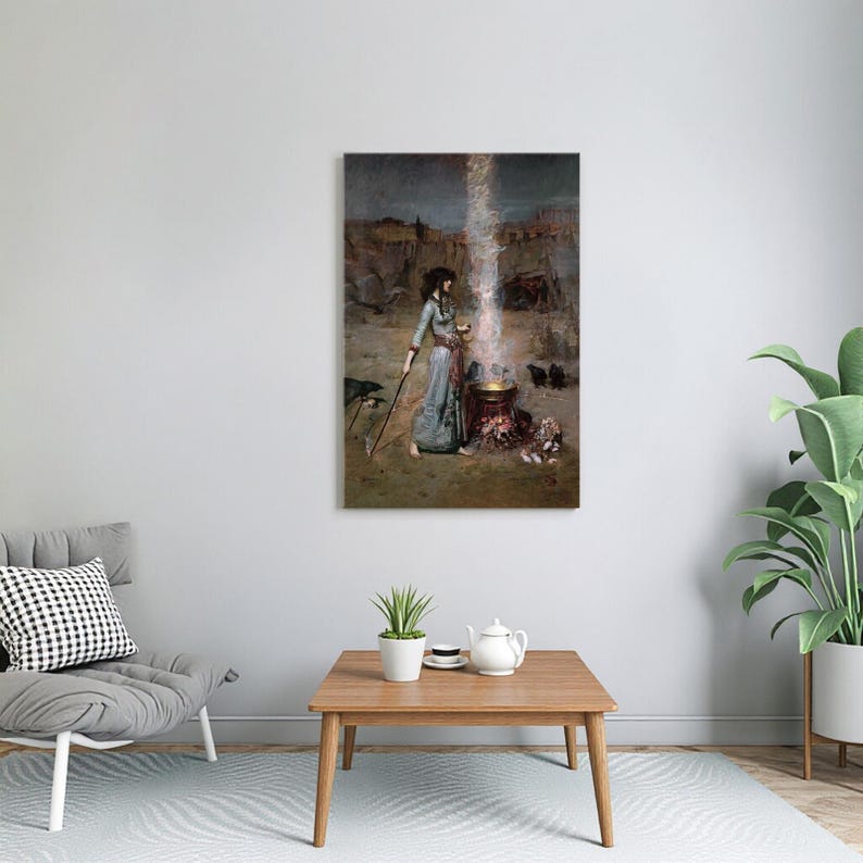 May include: A framed print of a painting depicting a woman in a long blue dress standing near a cauldron with a staff. A bright light emanates from the cauldron, with a dark, rocky landscape in the background.