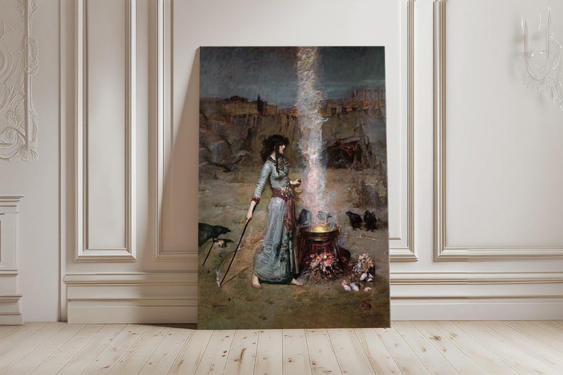 May include: A large framed canvas print of a painting depicting a woman in a long blue dress, holding a staff, standing near a cauldron with a bright light emanating from it. The background shows a desert landscape and a dark sky.