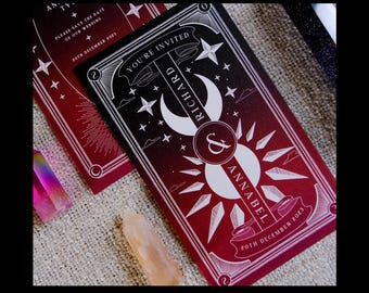 May include: Two wedding invitation cards with a dark red and black gradient design. The cards feature celestial elements like moons, stars, and suns, with the names "Richard & Annabel" and the date "20th December 2023". The text "YOU'RE INVITED" is also visible.