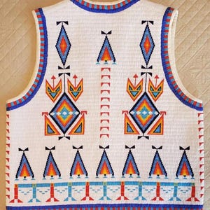 May include: White beaded vest with colorful geometric patterns. The design includes diamonds, triangles, and other shapes in shades of blue, orange, and red. The vest has a blue and red beaded trim.