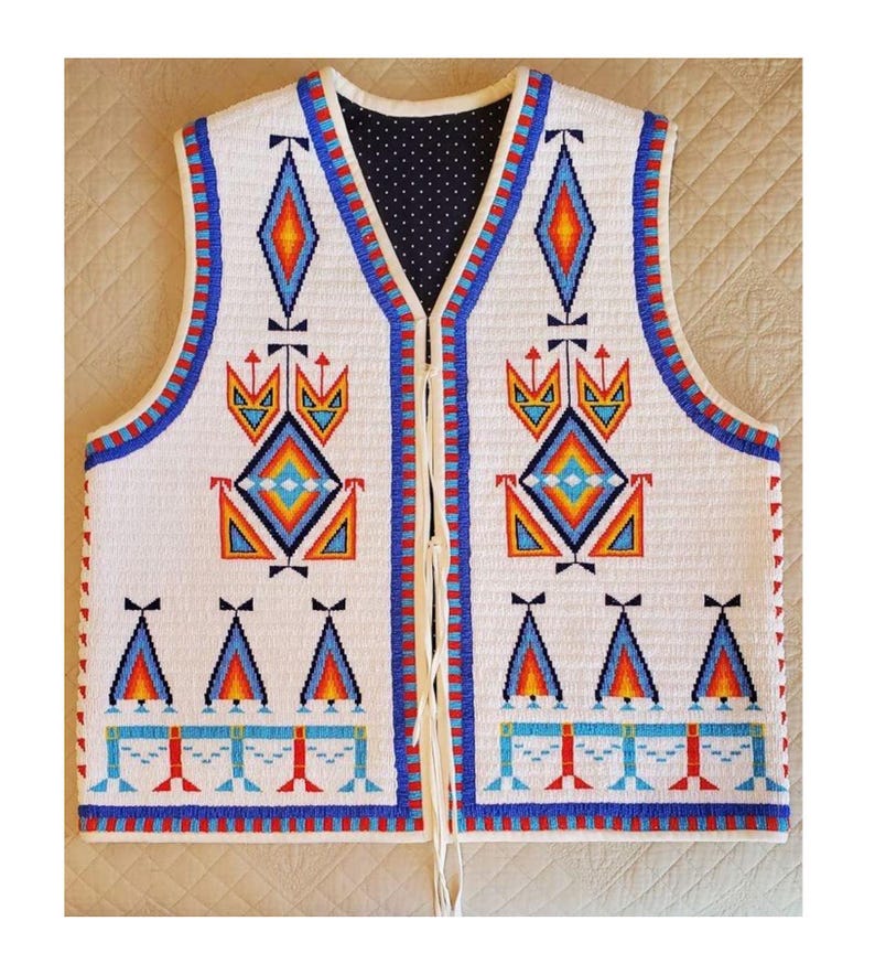 May include: White beaded vest with intricate geometric patterns in blue, orange, and red. The vest features a navy blue polka dot lining and a cream-colored drawstring closure. The design includes diamond and triangle shapes.