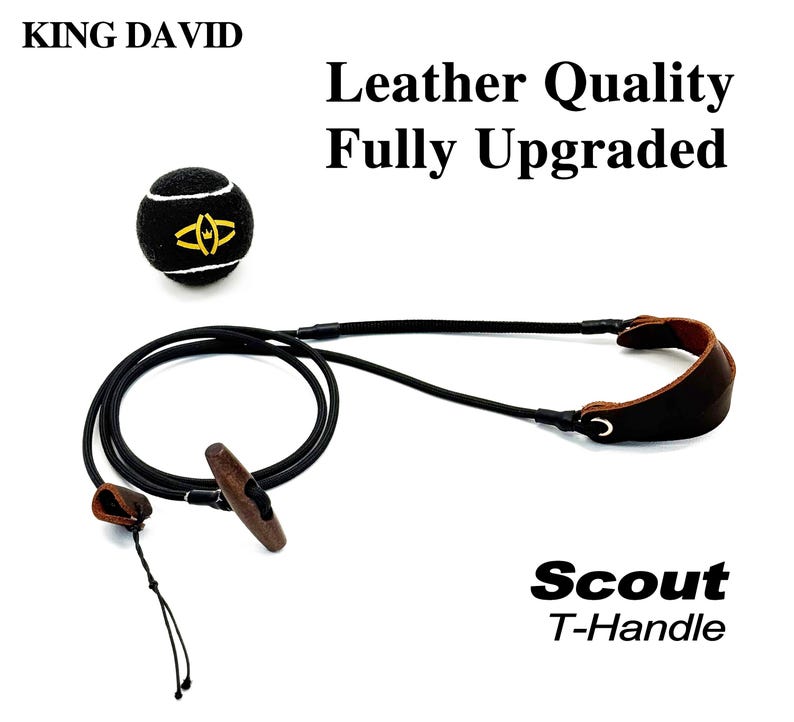 May include: A black tennis ball with a yellow logo and white lines, accompanied by a black cord with a brown wooden T-handle and a brown leather strap. Text reads: KING DAVID, Leather Quality Fully Upgraded, and Scout T-Handle.