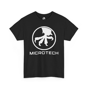 May include: Black t-shirt with a white graphic of a stylized claw inside a white circle. The word "MICROTECH" is printed in white below the circle. The shirt has a crew neck and short sleeves.